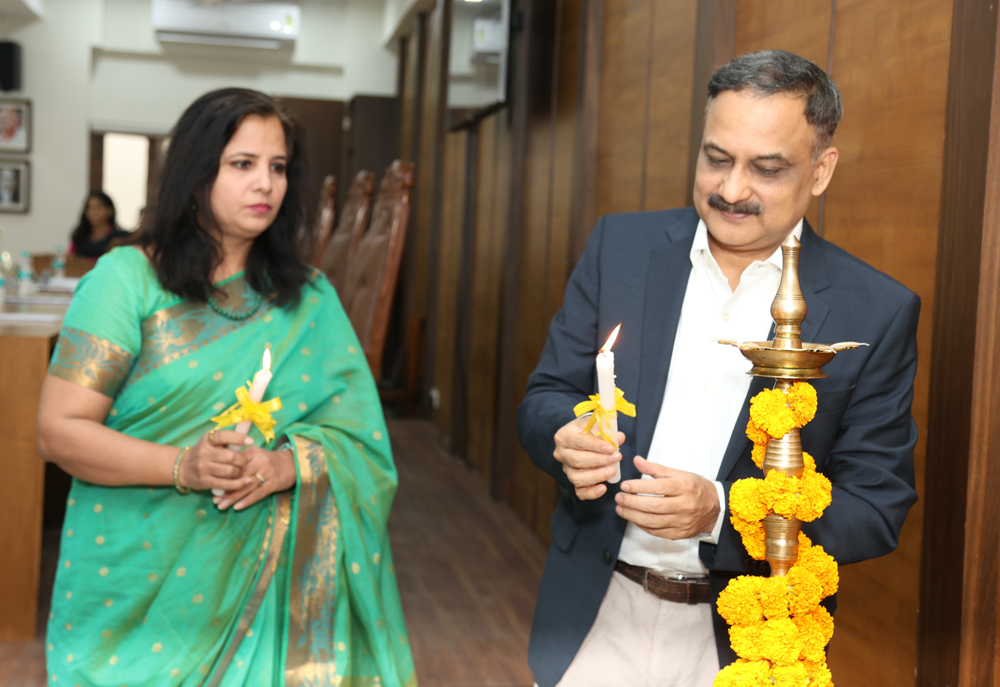 Distinguished Guest lighting the ceremonial lamp with Principal